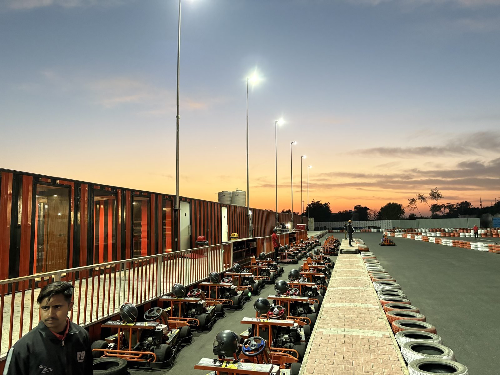 Karts lined up under floodlights at golden hour, F9 Go Karting Bhigan Ganaur